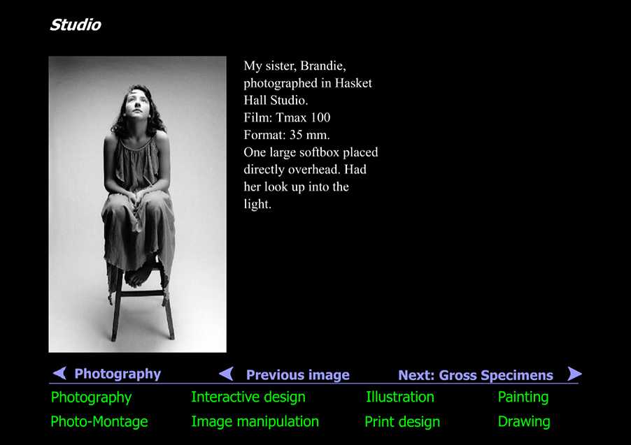 Young woman in studio looking up into light
